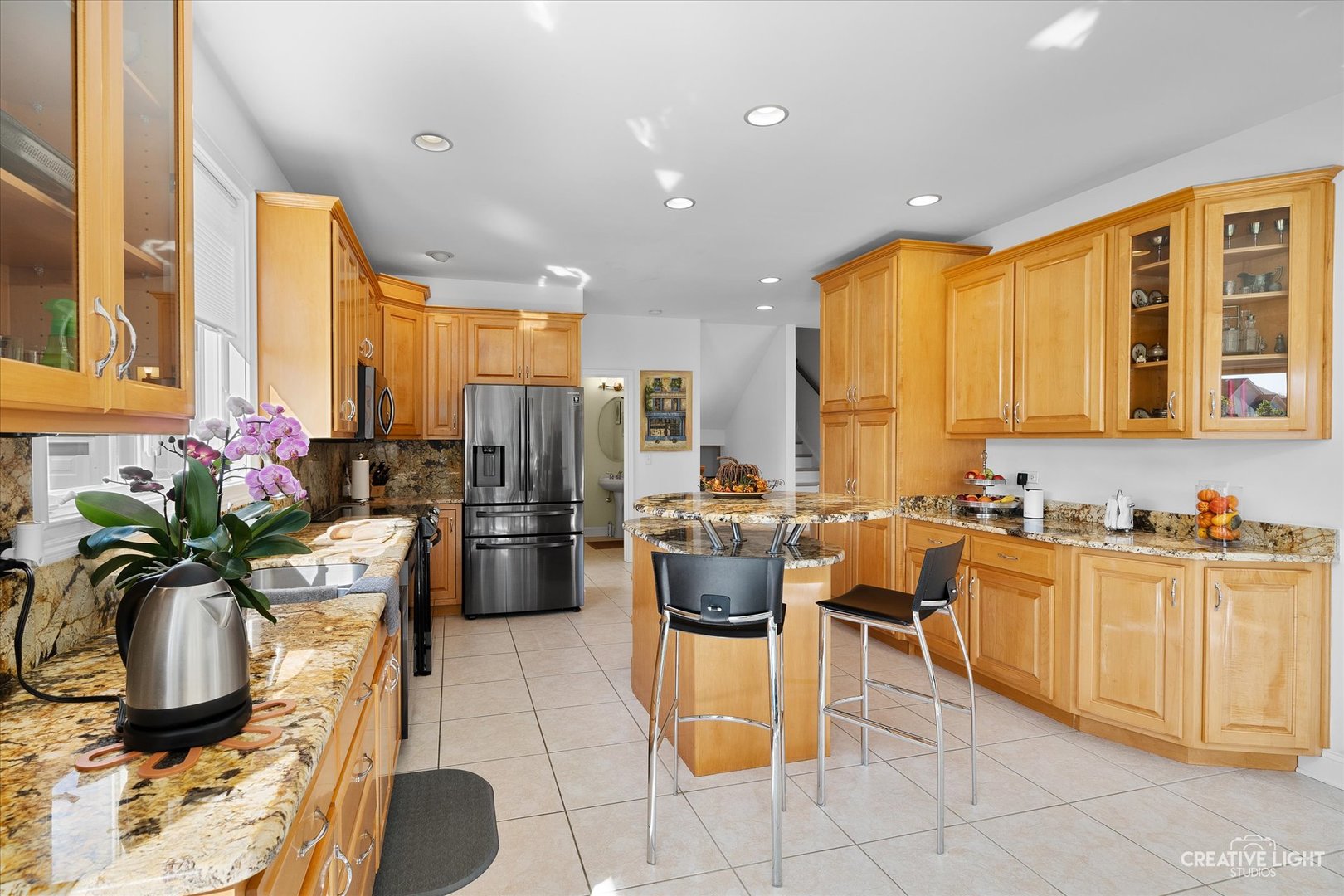 3912 Highknob Circle Naperville, IL 60564 - Photo 12 of 42 a kitchen with stainless steel appliances kitchen island granite countertop a refrigerator a sink a dining table and chairs