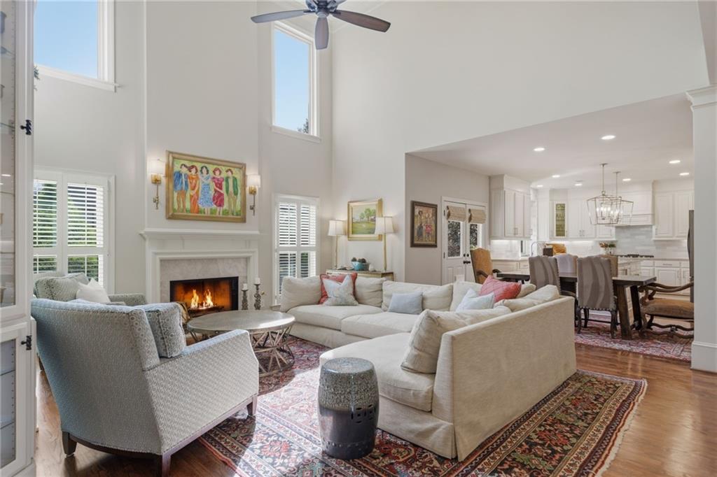 535 Brayford Way Suwanee, GA 30024 - Photo 11 of 55 a living room with furniture a fireplace and a chandelier