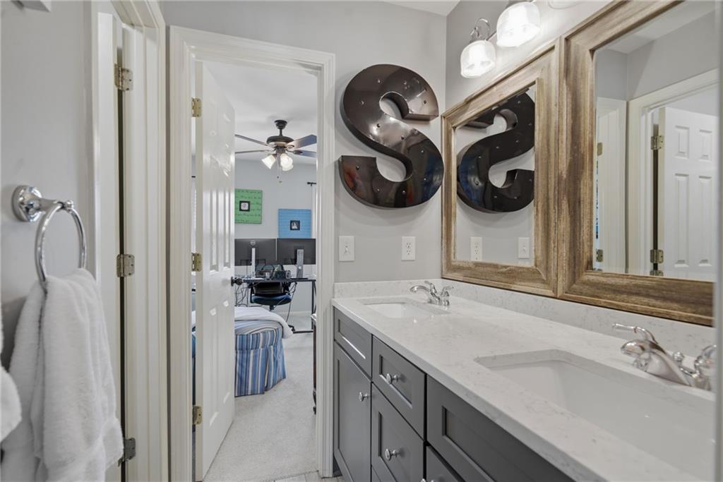 535 Brayford Way Suwanee, GA 30024 - Photo 23 of 55 a bathroom with a sink and a mirror