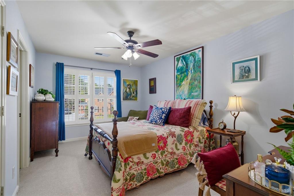 535 Brayford Way Suwanee, GA 30024 - Photo 25 of 55 a bedroom with a bed and a chandelier