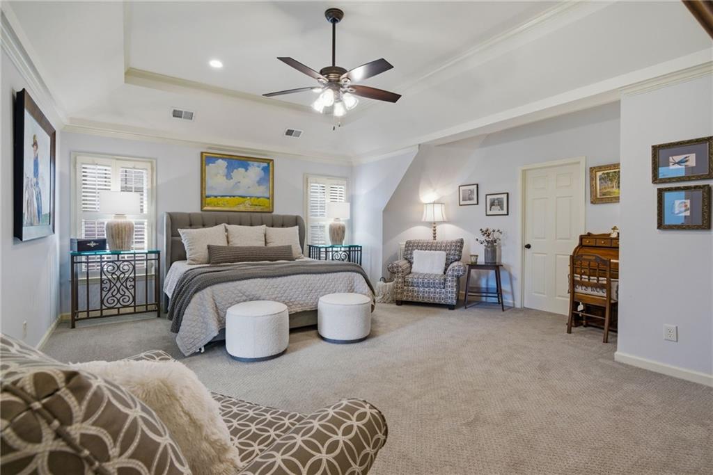 535 Brayford Way Suwanee, GA 30024 - Photo 27 of 55 a bedroom with furniture and a chandelier
