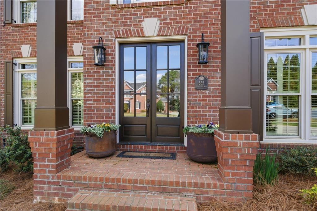 535 Brayford Way Suwanee, GA 30024 - Photo 3 of 55 a view of a house with a potted plant and floor to ceiling windows