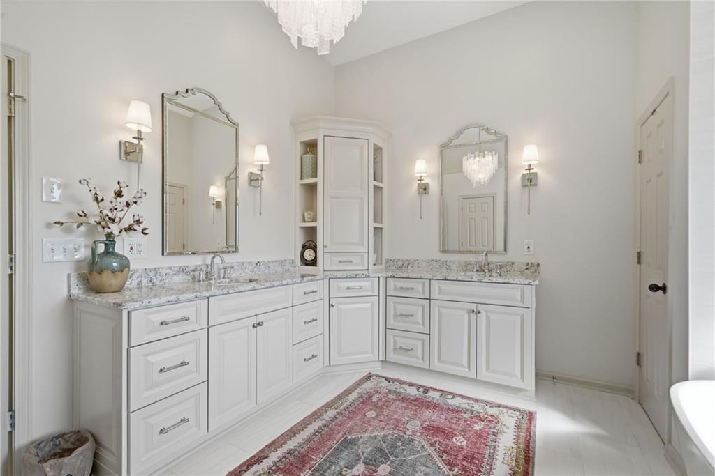 535 Brayford Way Suwanee, GA 30024 - Photo 32 of 55 a spacious bathroom with a granite countertop sink a toilet a mirror and shower