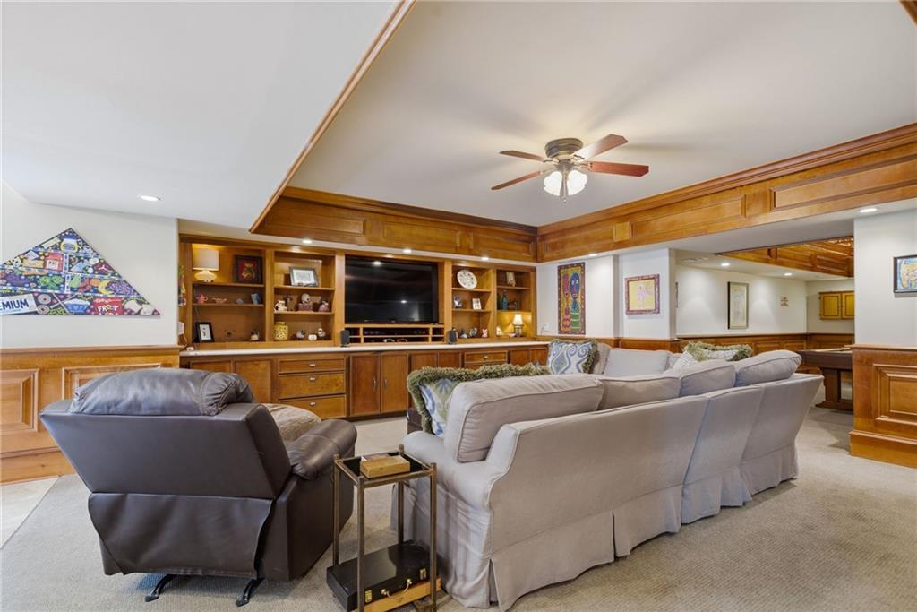 535 Brayford Way Suwanee, GA 30024 - Photo 39 of 55 a living room with furniture and a ceiling fan