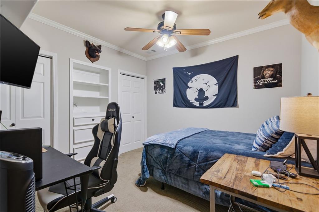 535 Brayford Way Suwanee, GA 30024 - Photo 42 of 55 a bedroom with a bed and a flat screen tv