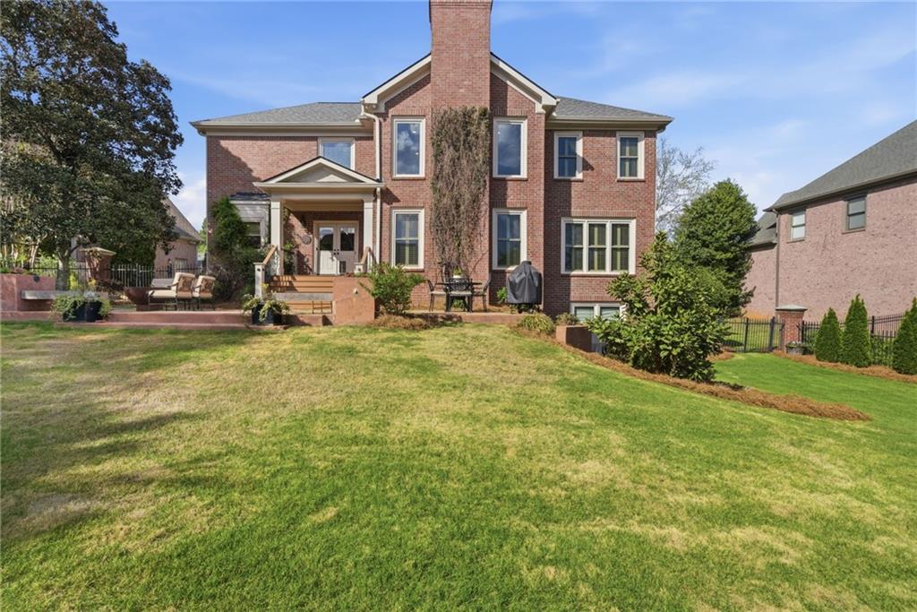 535 Brayford Way Suwanee, GA 30024 - Photo 46 of 55 a front view of a house with garden and porch