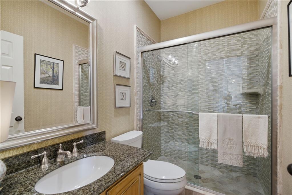 535 Brayford Way Suwanee, GA 30024 - Photo 10 of 55 a bathroom with a granite countertop sink toilet a mirror and shower