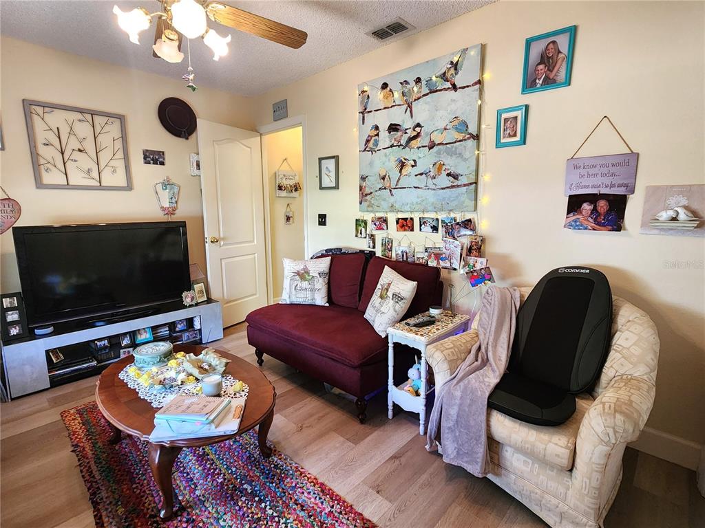 1701 Southeast 24th Road, Unit 1601 Ocala, FL 34471 - Photo 18 of 30 a living room with furniture and a flat screen tv