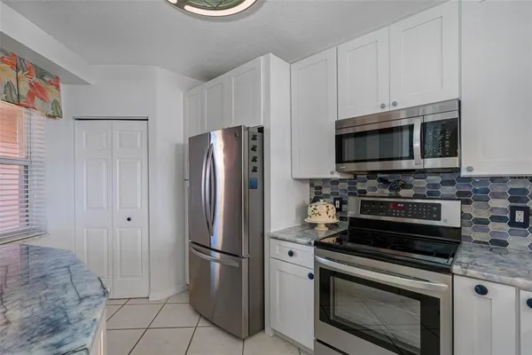a kitchen with stainless steel appliances a refrigerator stove and microwave