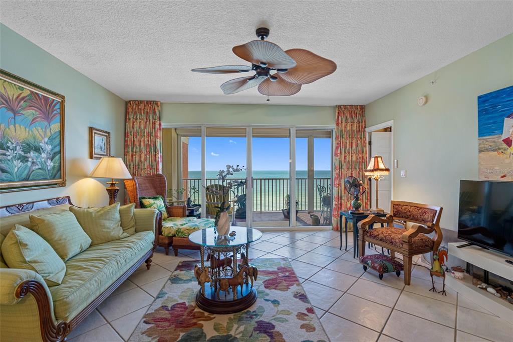 16550 Gulf Boulevard, Unit 545 North Redington Beach, FL 33708 - Photo 15 of 64 a living room with fireplace furniture and a large window