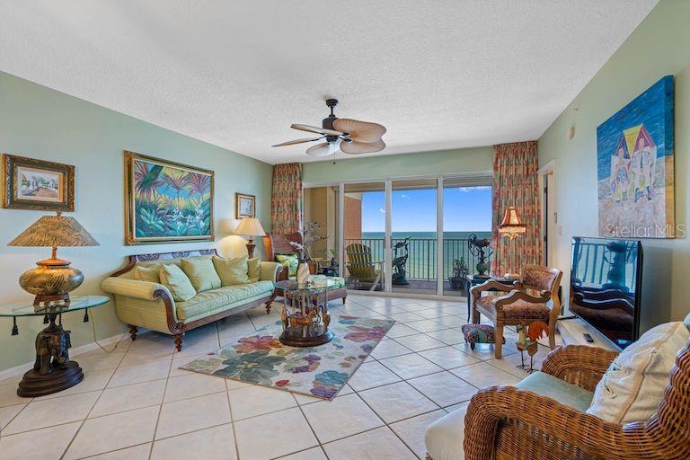 16550 Gulf Boulevard, Unit 545 North Redington Beach, FL 33708 - Photo 16 of 64 a living room with furniture a chandelier and a table