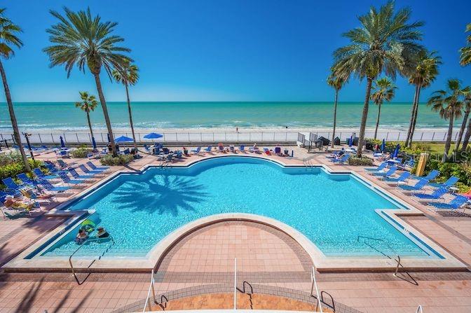16550 Gulf Boulevard, Unit 545 North Redington Beach, FL 33708 - Photo 2 of 64 a view of swimming pool with outdoor seating and a garden