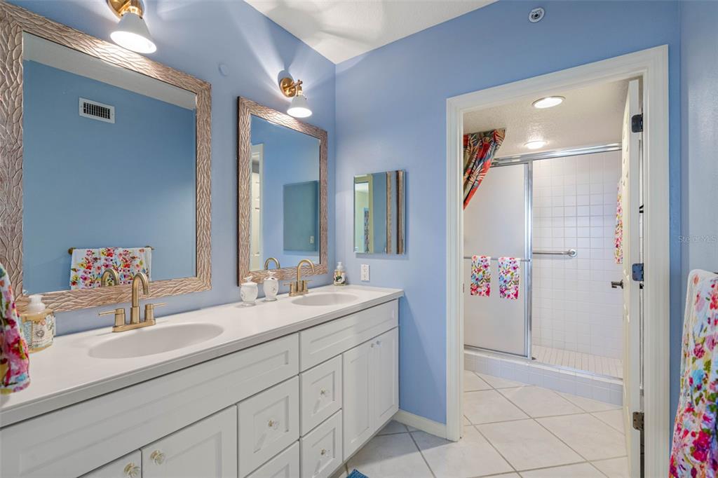 16550 Gulf Boulevard, Unit 545 North Redington Beach, FL 33708 - Photo 26 of 64 a bathroom with a sink and a mirror