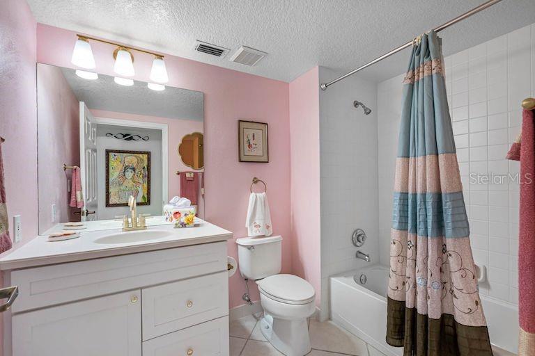 16550 Gulf Boulevard, Unit 545 North Redington Beach, FL 33708 - Photo 31 of 64 a bathroom with a toilet a sink and a mirror