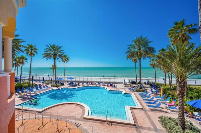 a living room with patio furniture and a large window