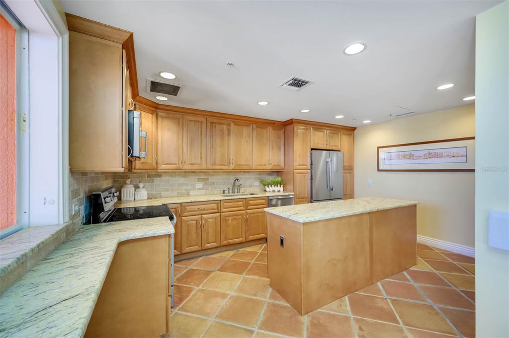 16550 Gulf Boulevard, Unit 545 North Redington Beach, FL 33708 - Photo 55 of 64 a kitchen with stainless steel appliances granite countertop a sink and a refrigerator