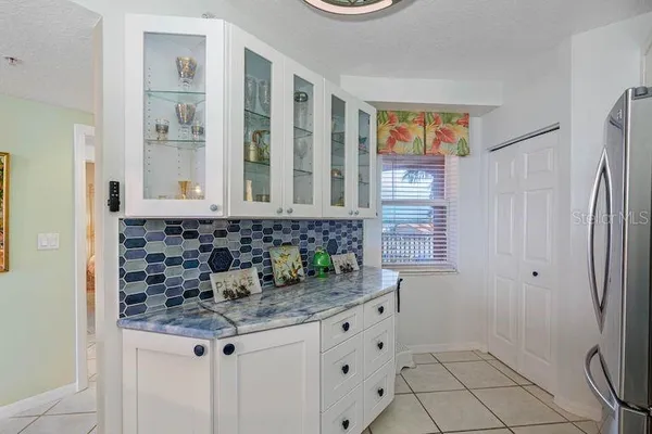 a bathroom with a granite countertop sink a mirror and a shower