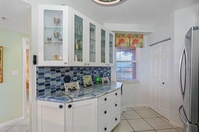 a bathroom with a granite countertop sink a mirror and a shower