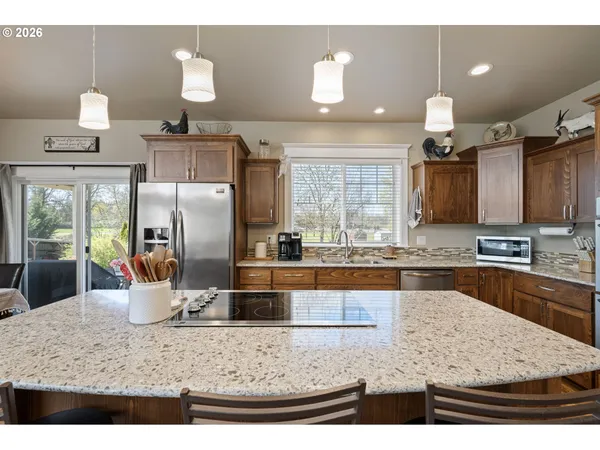 a kitchen with a stove a refrigerator and a sink