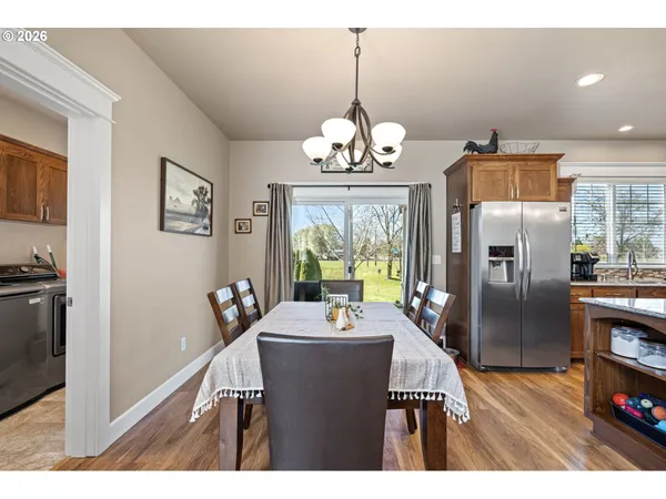 a view of a dining room with furniture large window and refrigerator