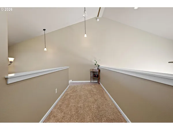 a view of a livingroom with floor to ceiling window and stairs