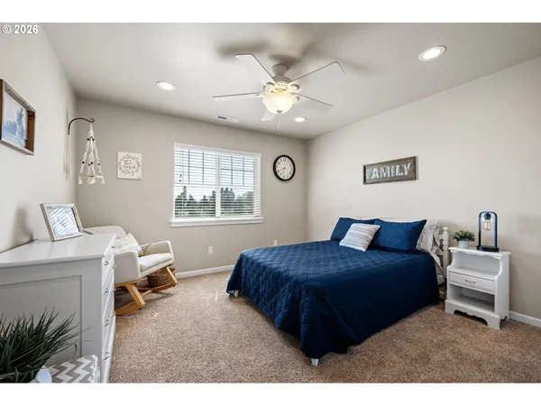a bedroom with a large bed and a window