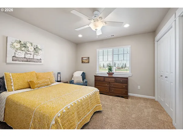 a spacious bedroom with a bed and a chandelier
