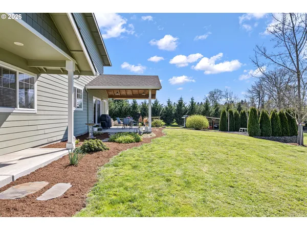a swimming pool with outdoor seating and yard