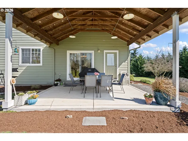 a view of a patio with table and chairs and potted plants