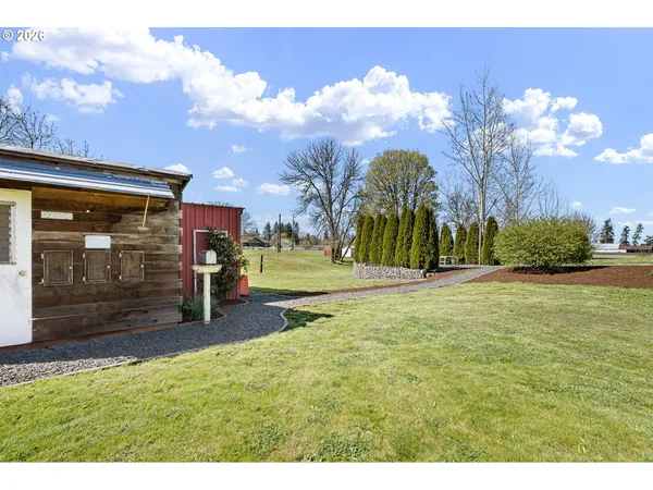 a backyard of a house with table and chairs