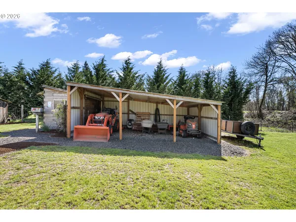 a view of a house with backyard and sitting area