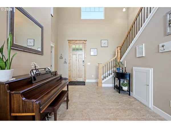 a living room with furniture and a piano