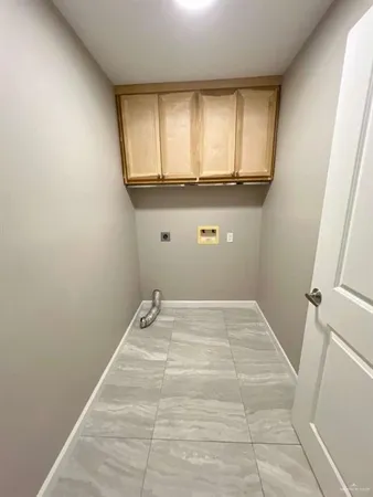 a view of a kitchen with wooden floor and cabinets