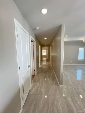 a view of hallway with wooden floor