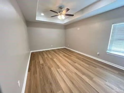 wooden floor in an empty room with a window