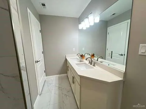 a bathroom with a sink vanity and a mirror