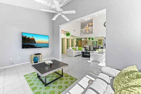 a living room with furniture a rug and a flat screen tv