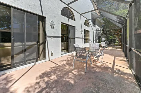 a view of a patio with table and chairs and potted plants