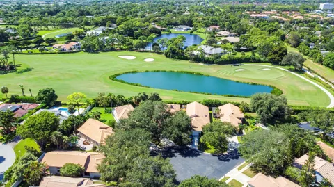 an aerial view of a house with a yard and lake view