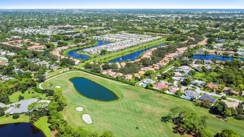 an aerial view of residential houses with outdoor space and trees