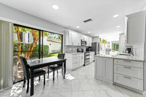 a kitchen with a stove a sink a counter top space and appliances