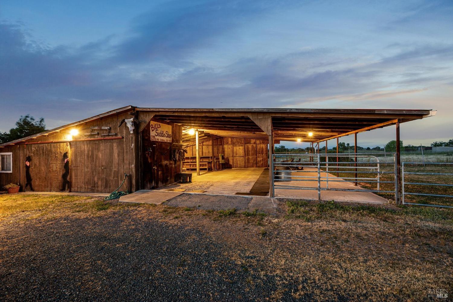 23180 Maffei Road Sonoma, CA 95476 - Photo 10 of 61 Outbuilding #4 Barn with open walls for feed storage, covered paddocks, which opens to interior tack room and additional rooms.