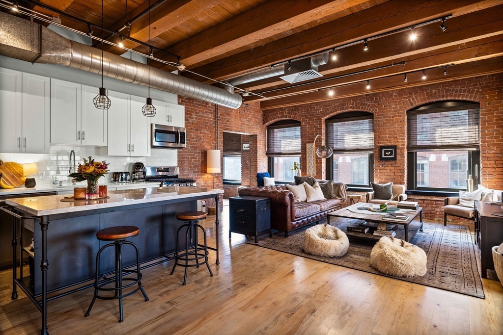 21 Wormwood Street, Unit 412 Boston, MA 02210 - Photo 4 of 11 a room with lots of furniture and white appliances