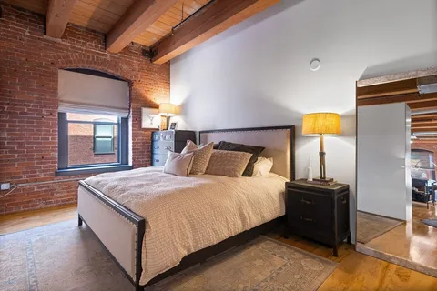 a bedroom with bed and window