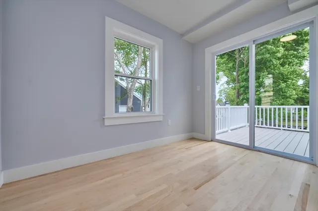 a view of a room with wooden floor and windows