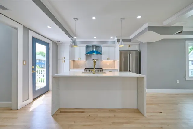 a view of kitchen with stainless steel appliances granite countertop cabinets and wooden floor