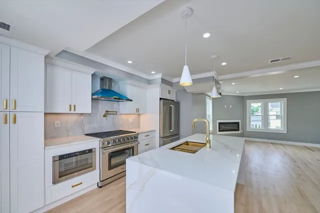 a kitchen with granite countertop a stove top oven and cabinets