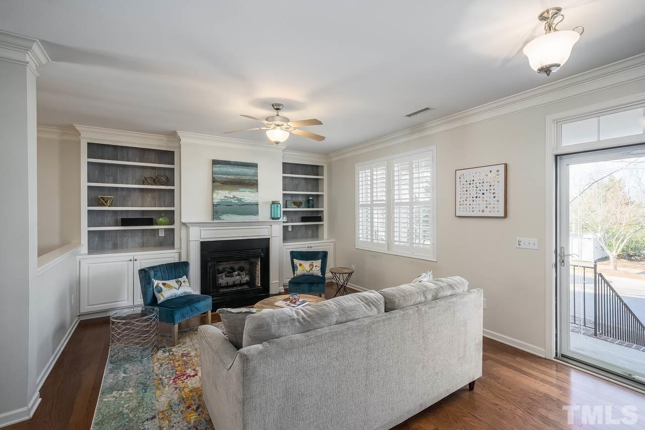2707 Cloud Mist Circle Raleigh, NC 27614 - Photo 3 of 28 Spacious living room with gas fireplace and built-in shelving.