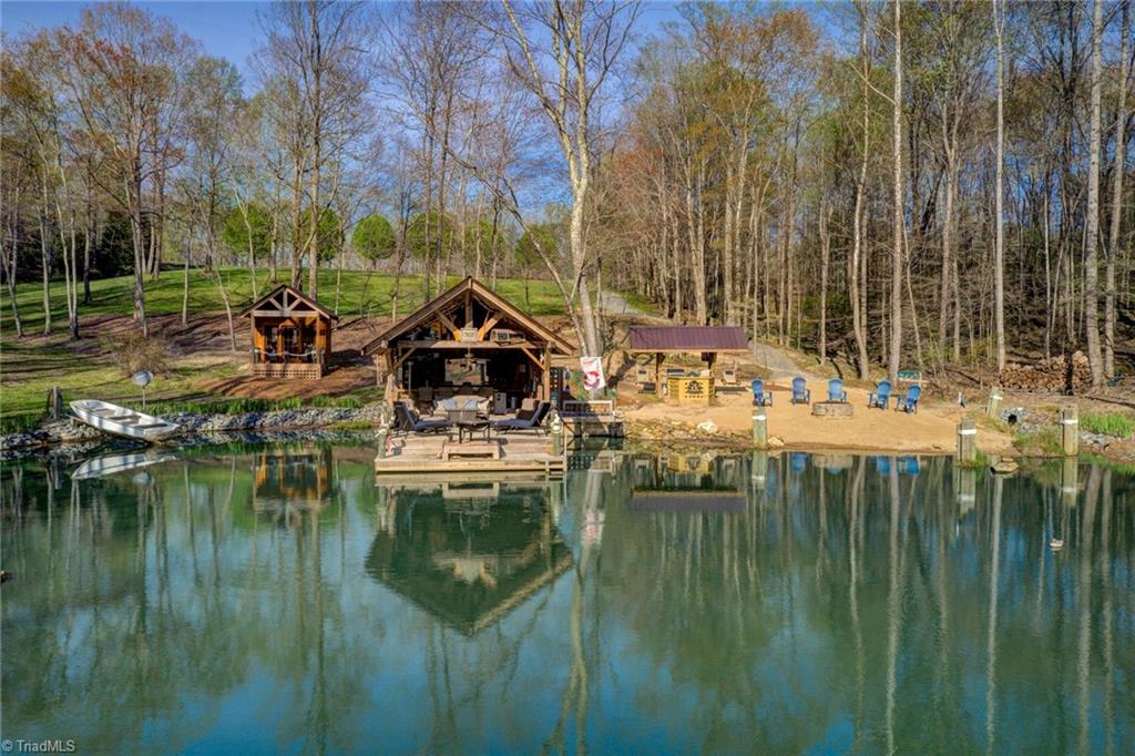 1197 Big Oak Road Germanton, NC 27019 - Photo 3 of 49 Pond with beach area, deck for entertaining (tv wet bar) firepit bathhouse.