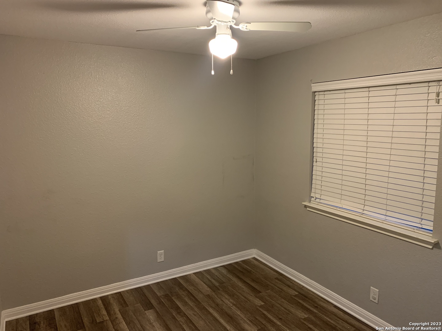4618 Everett Loop Converse, TX 78109 - Photo 14 of 20 wooden floor in an empty room with a window